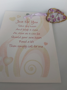 Little heart hangers with coloured gems Held by ribbon on a pretty card A heartfelt gift